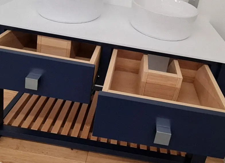 A blue Vanity unit with its drawers open showing ample storage space