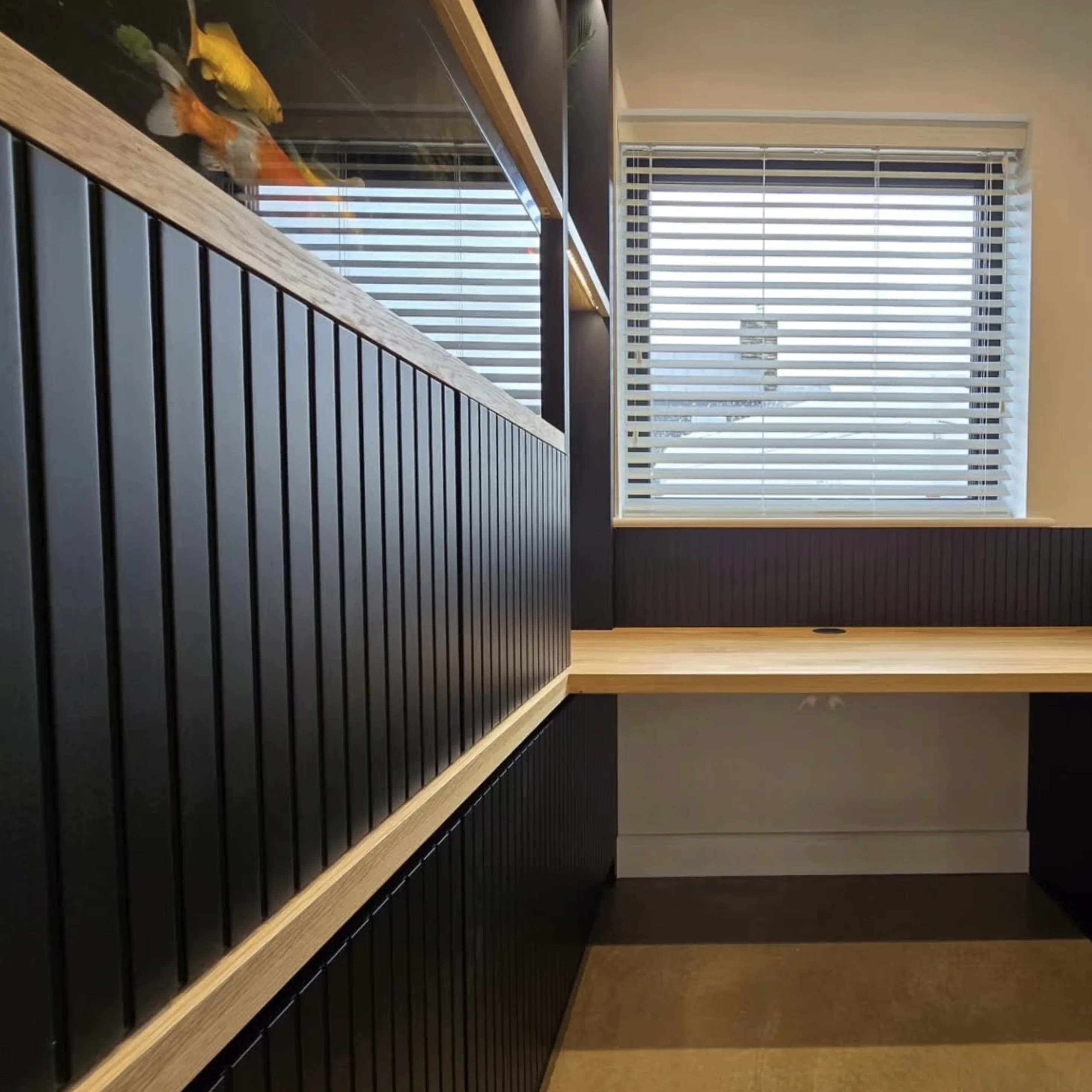 Close-up detail of dark fluted paneling and oak desk craftsmanship
